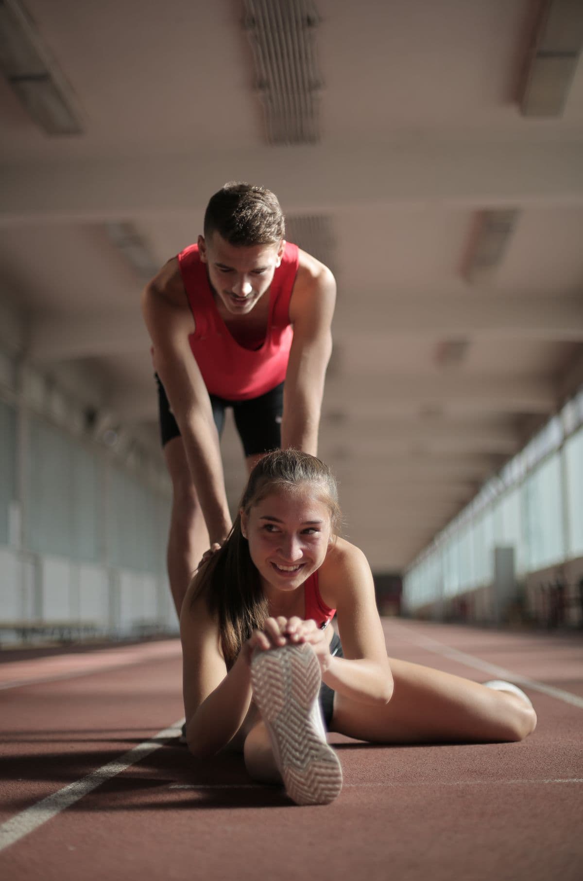 Trainer and client stretching together after exercise